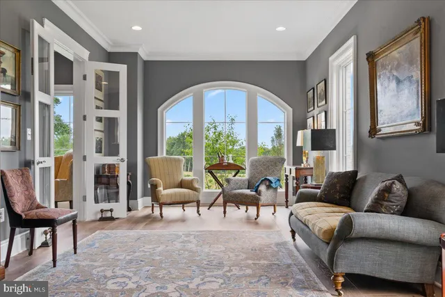 a bedroom with lots of clutter and white cabinets