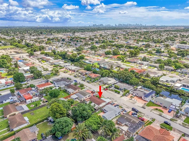 an aerial view of residential houses with outdoor space