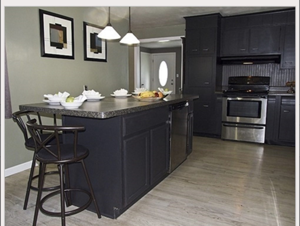 19 Simone Street Worcester, MA 01604 - Photo 9 of 14 a kitchen with stainless steel appliances granite countertop a stove and cabinets