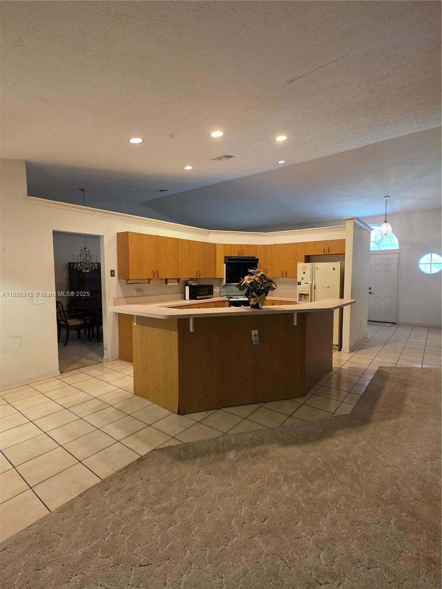 4802 Matanzas Avenue Fort Pierce, FL 34946 - Photo 11 of 28 a kitchen with kitchen island and a stove