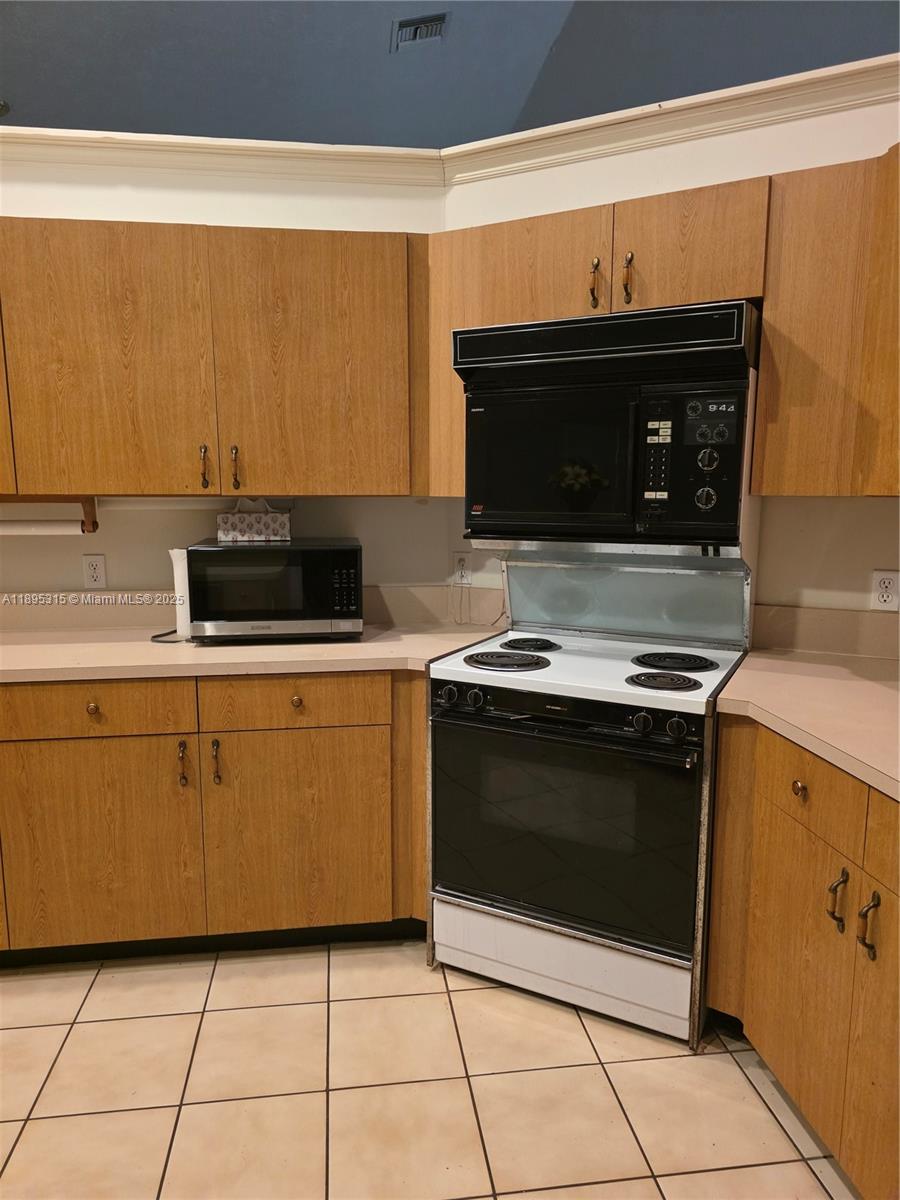 4802 Matanzas Avenue Fort Pierce, FL 34946 - Photo 12 of 28 a kitchen with granite countertop a stove and a microwave