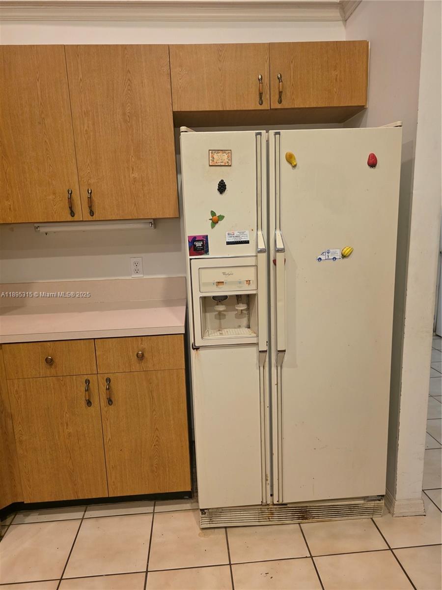 4802 Matanzas Avenue Fort Pierce, FL 34946 - Photo 13 of 28 a white refrigerator freezer sitting in a kitchen