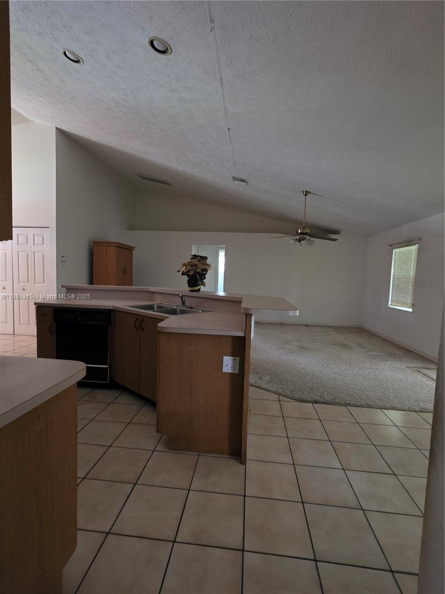 4802 Matanzas Avenue Fort Pierce, FL 34946 - Photo 15 of 28 a kitchen with stainless steel appliances a sink stove and cabinets