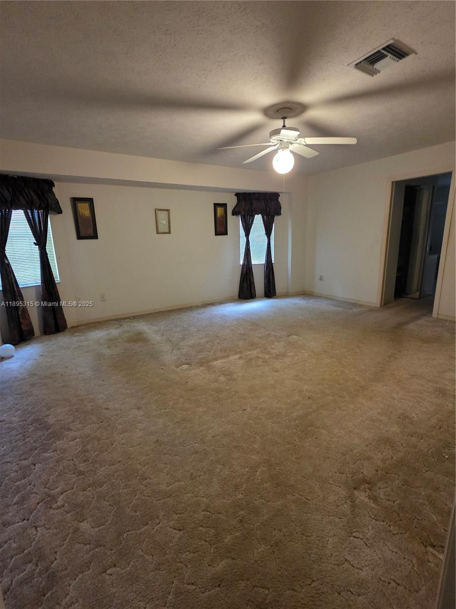 4802 Matanzas Avenue Fort Pierce, FL 34946 - Photo 4 of 28 a view of empty room with ceiling fan