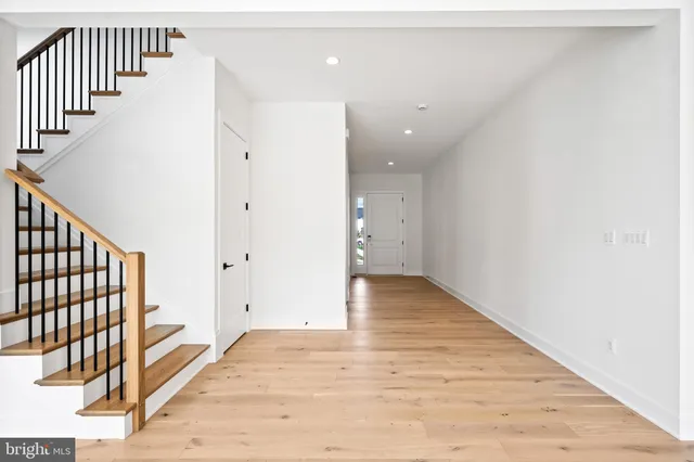 a spacious bathroom with a granite countertop sink and a mirror