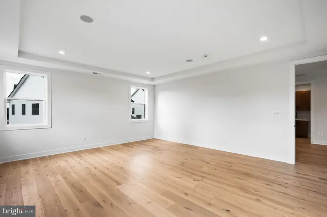 an empty room with windows and cabinet