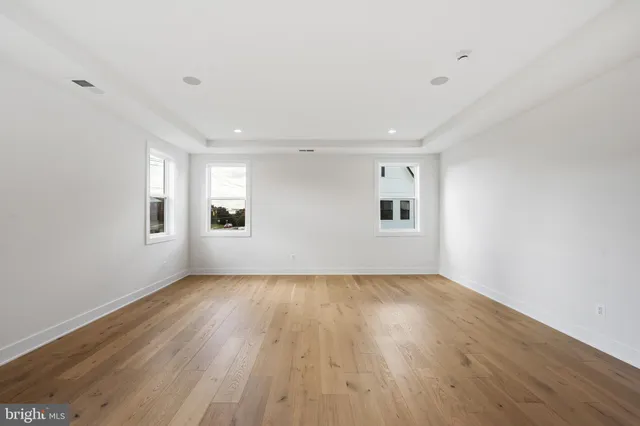 a view of a room with wooden floor and fan