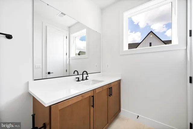 a view of walk in closet with racks on the wall