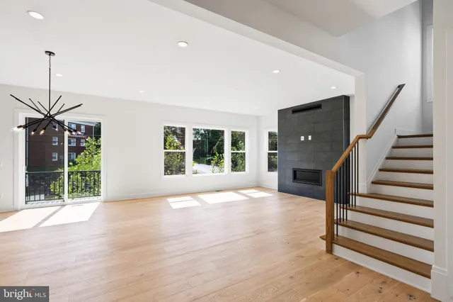 a view of an empty room with a fireplace and a window