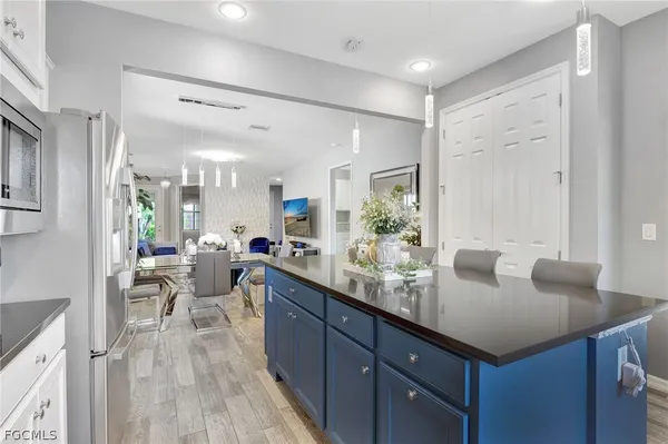 a kitchen with sink cabinets and living room