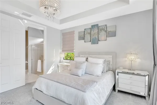 a bed room with a bed and a chandelier