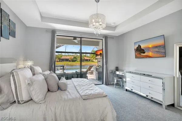 a bedroom with furniture and a large window