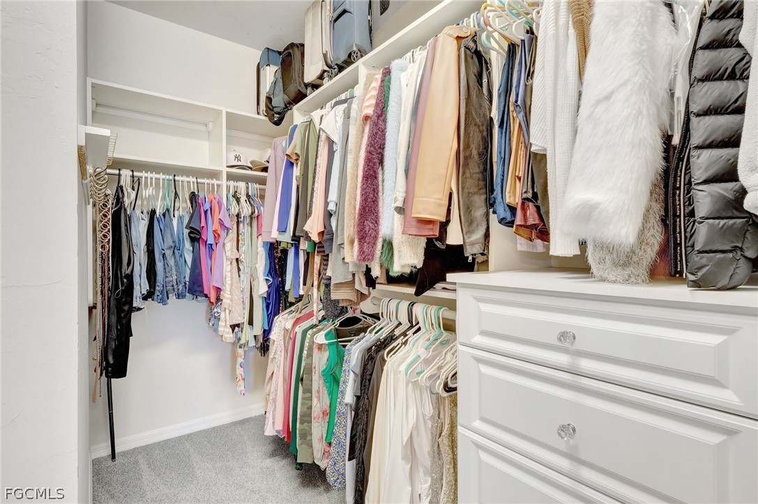 10908 Clarendon Street Fort Myers, FL 33913 - Photo 21 of 49 a view of walk in closet with clothes and shoes