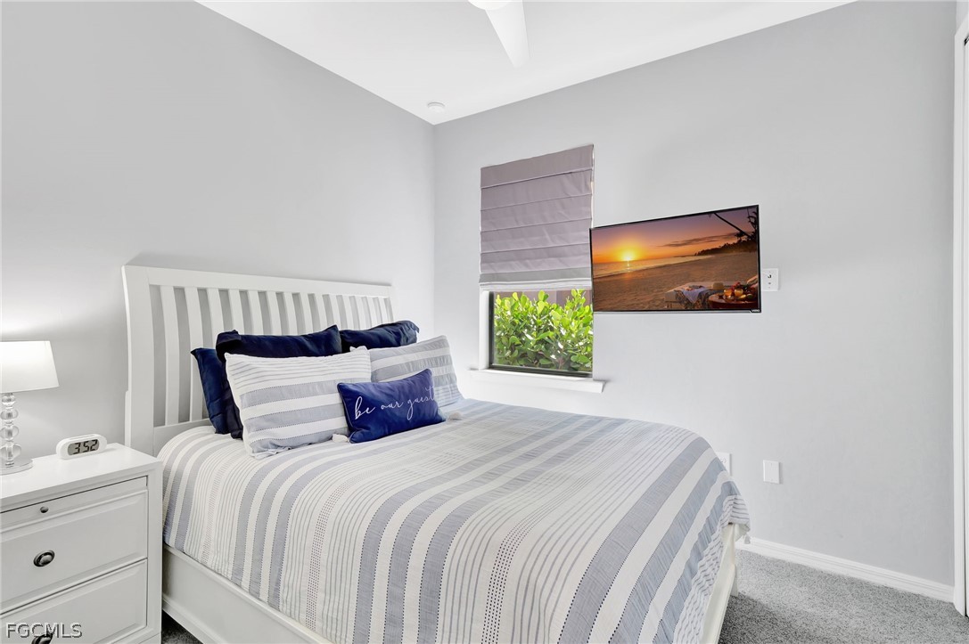 10908 Clarendon Street Fort Myers, FL 33913 - Photo 22 of 49 a bedroom with a bed and a flat screen tv
