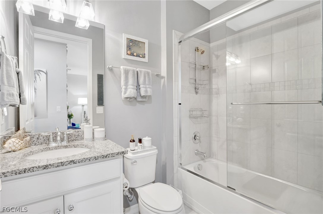 10908 Clarendon Street Fort Myers, FL 33913 - Photo 24 of 49 a bathroom with a granite countertop sink toilet and shower