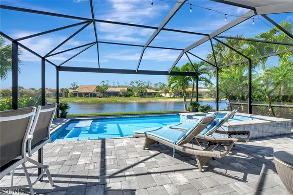 a view of a patio with a table and chairs under an umbrella