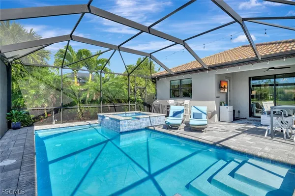 a view of a backyard with table and chairs under an umbrella
