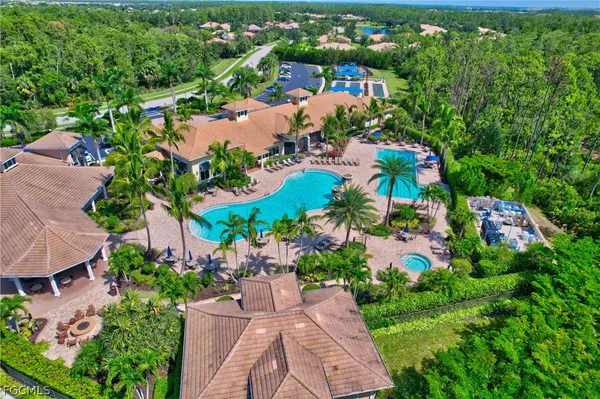 an aerial view of a house with garden space and lake view