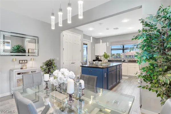 a kitchen with kitchen island granite countertop a table and chairs
