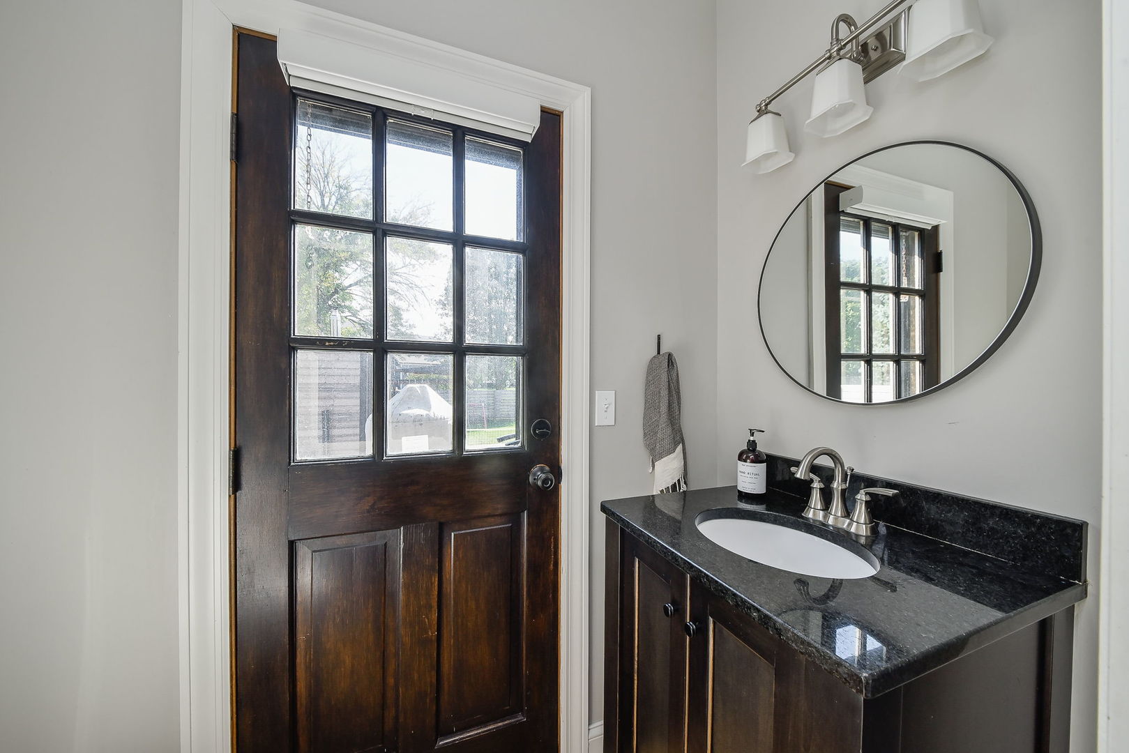 24 Winners Cup Circle Wheaton, IL 60189 - Photo 19 of 46 a bathroom with a granite countertop sink a mirror and a window