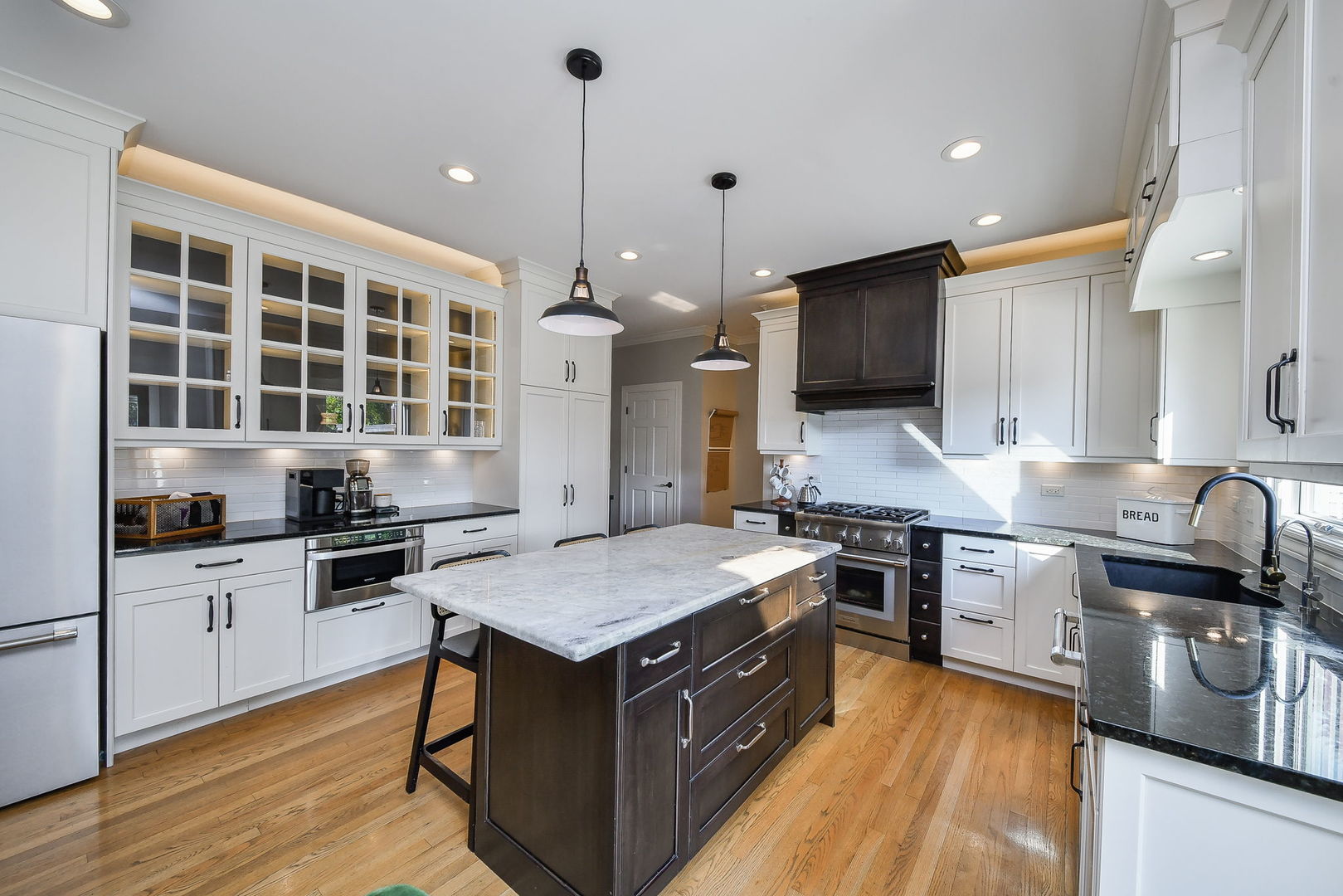 24 Winners Cup Circle Wheaton, IL 60189 - Photo 9 of 46 a kitchen with granite countertop a sink stove and wooden floor