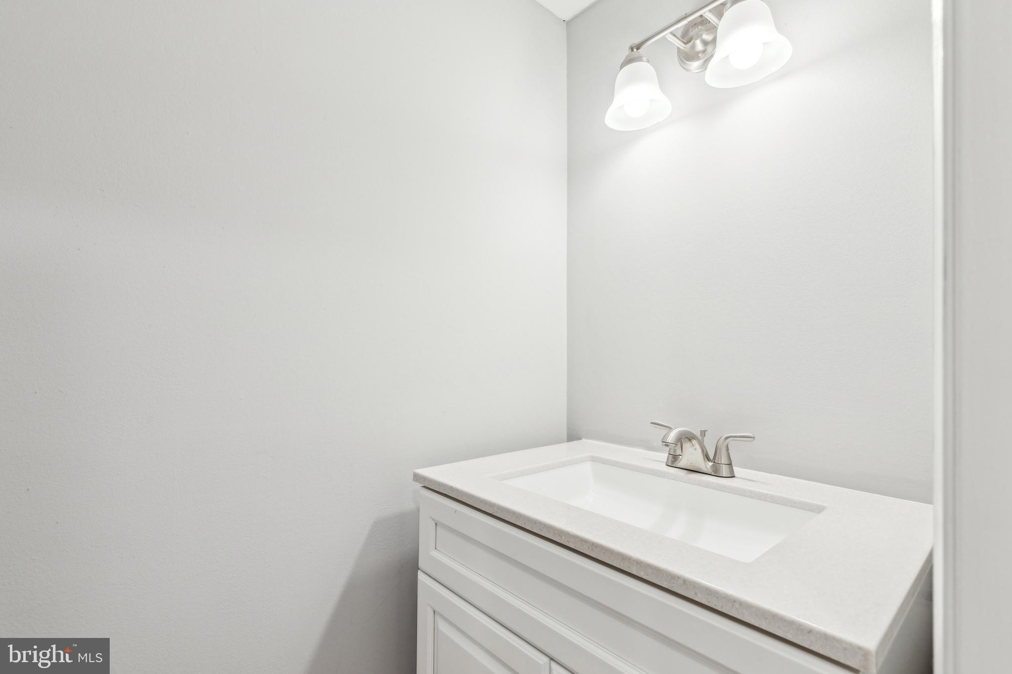 712 North Duncan Street Baltimore, MD 21205 - Photo 12 of 27 a bathroom with a sink and a mirror