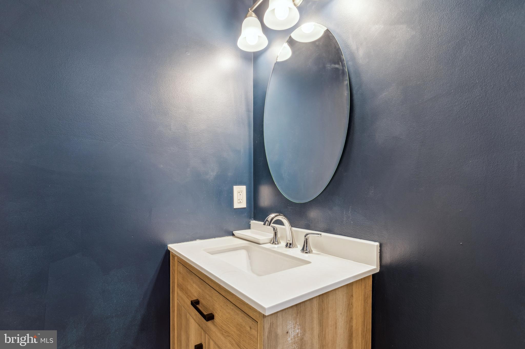 712 North Duncan Street Baltimore, MD 21205 - Photo 18 of 27 a bathroom with a sink and a mirror
