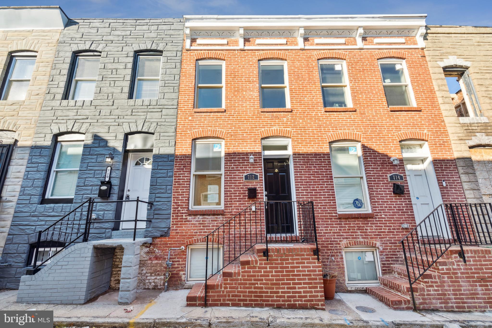 712 North Duncan Street Baltimore, MD 21205 - Photo 4 of 27 a front view of a building with glass windows