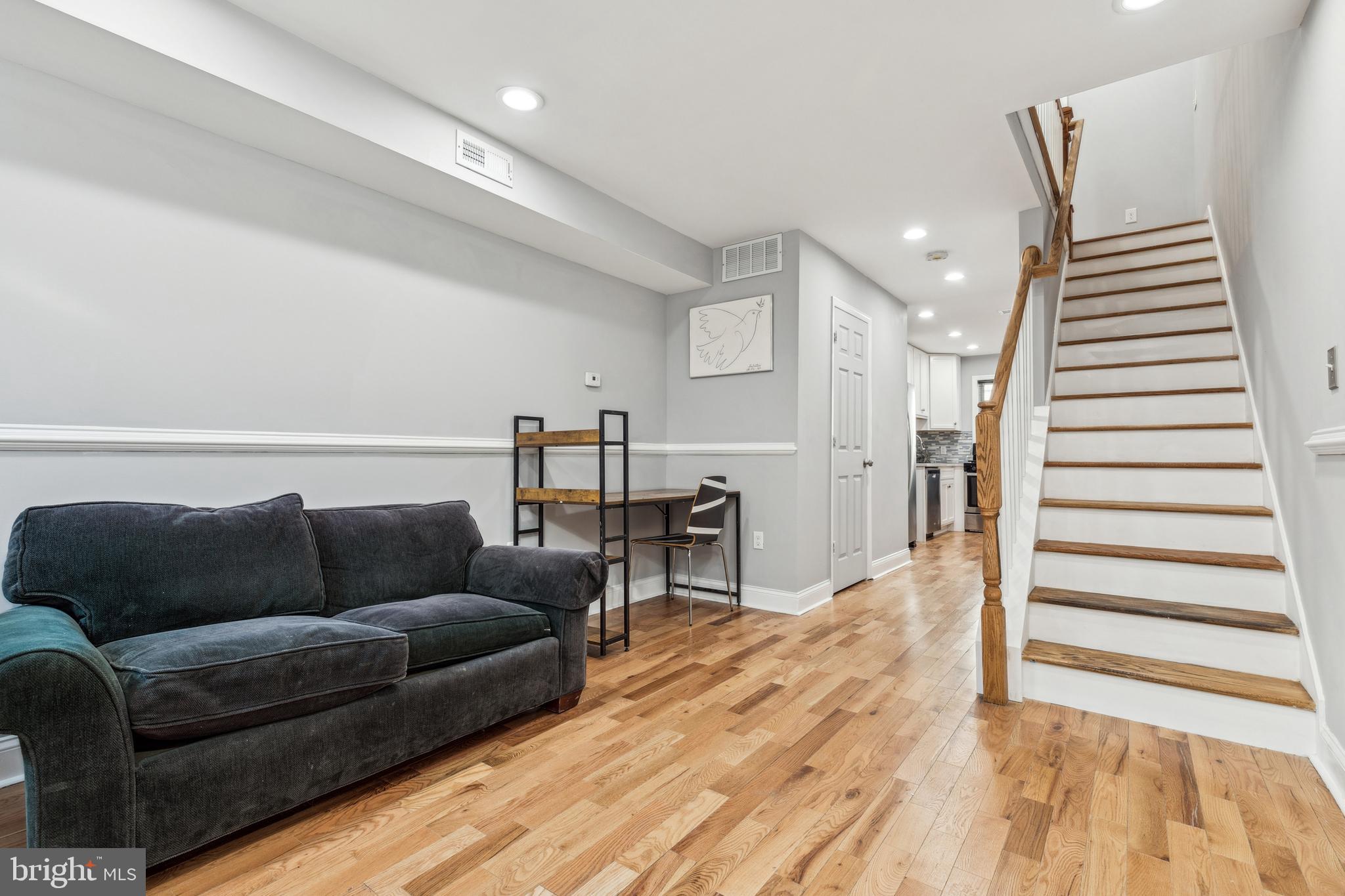 712 North Duncan Street Baltimore, MD 21205 - Photo 6 of 27 a living room with furniture and wooden floor