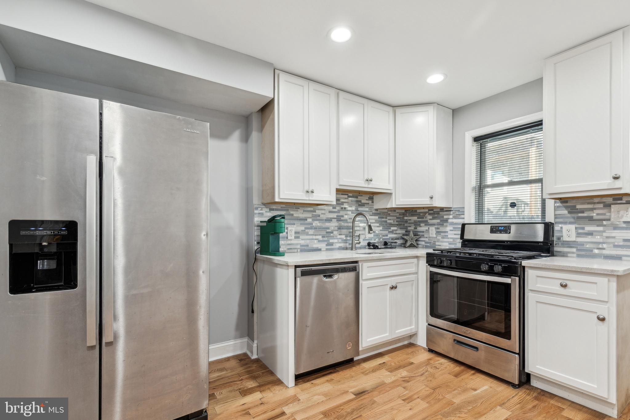 712 North Duncan Street Baltimore, MD 21205 - Photo 8 of 27 a kitchen with stainless steel appliances granite countertop a stove and a refrigerator