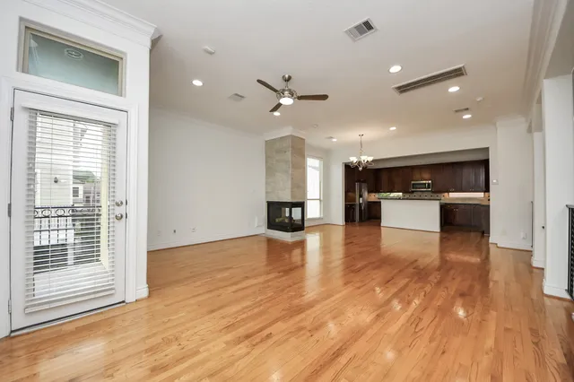 a large kitchen with stainless steel appliances kitchen island a large counter top and a wooden floors