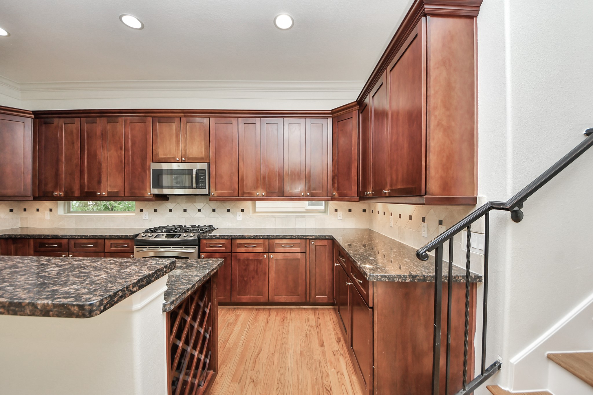5526 Crooms Street Houston, TX 77007 - Photo 24 of 49 a kitchen with stainless steel appliances granite countertop a stove a sink and a microwave