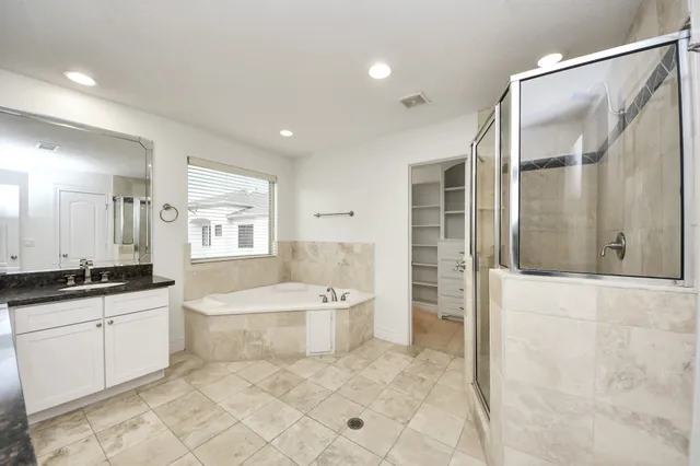 a large bathroom with a granite countertop sink and a mirror