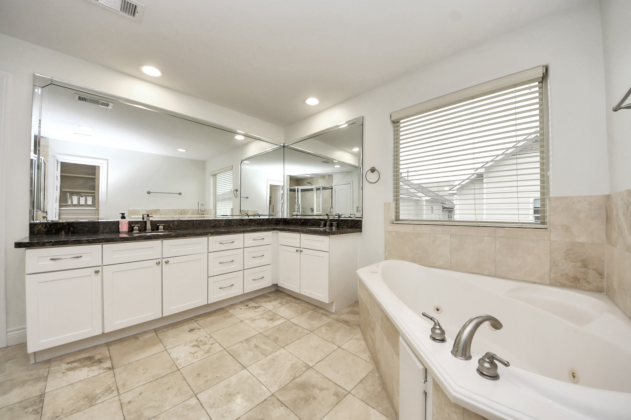 5526 Crooms Street Houston, TX 77007 - Photo 36 of 49 a large bathroom with a tub a sink a mirror and a shower