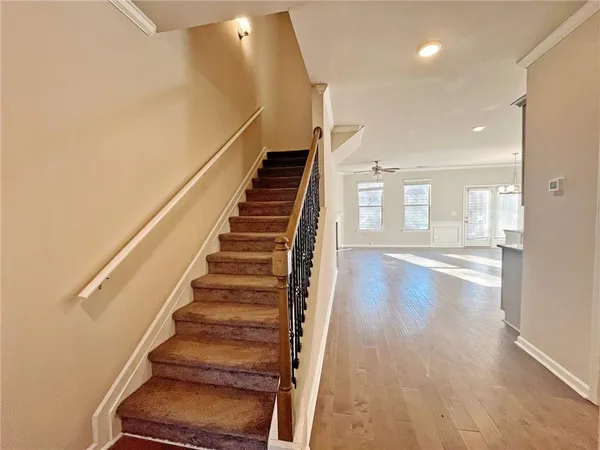 a view of entryway and hall with wooden floor