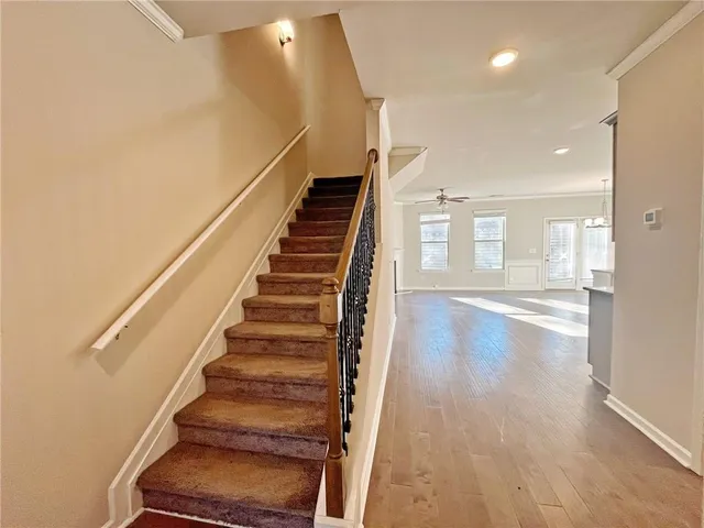 a view of entryway and hall with wooden floor