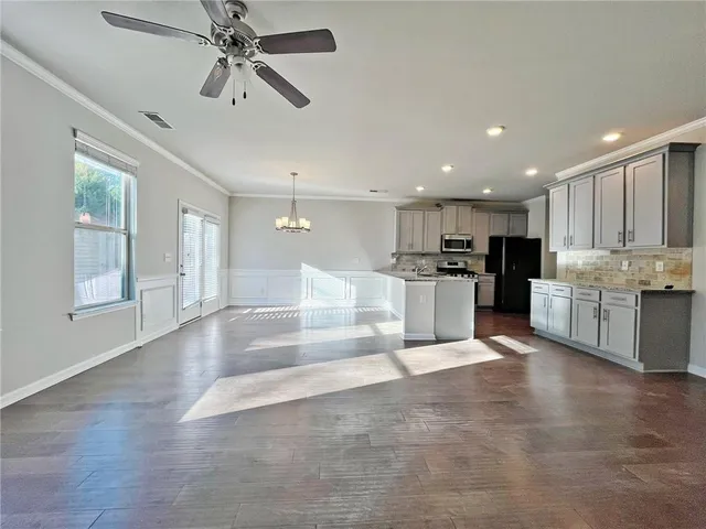 a view of kitchen with refrigerator and window