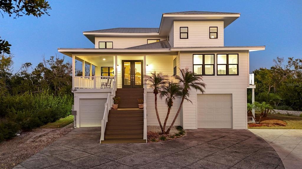 5010 Grouper Hole Court Boca Grande, FL 33921 - Photo 2 of 69 a front view of a house with a yard