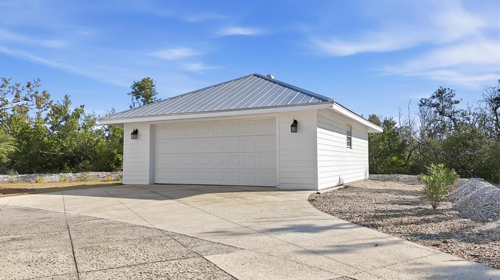 5010 Grouper Hole Court Boca Grande, FL 33921 - Photo 49 of 69 a front view of a house with a yard and garage