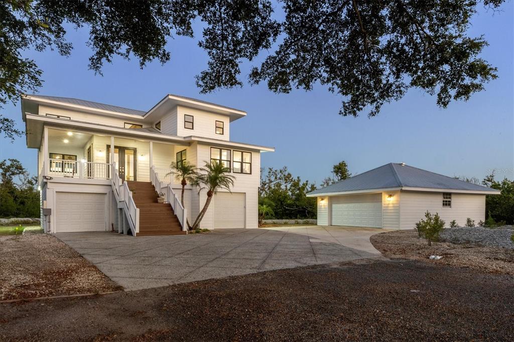 5010 Grouper Hole Court Boca Grande, FL 33921 - Photo 6 of 69 a front view of a house with garden