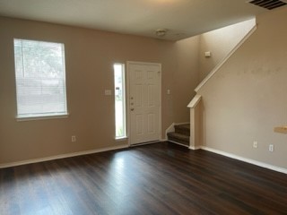 14112 Harris Ridge Boulevard, Unit B Pflugerville, TX 78660 - Photo 11 of 16 a view of an empty room with wooden floor and a window
