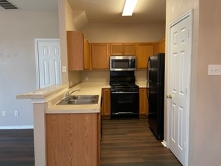 14112 Harris Ridge Boulevard, Unit B Pflugerville, TX 78660 - Photo 12 of 16 a kitchen with stainless steel appliances granite countertop a refrigerator and a stove