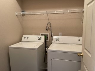 14112 Harris Ridge Boulevard, Unit B Pflugerville, TX 78660 - Photo 13 of 16 a utility room with dryer and washer
