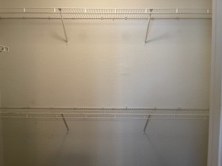 14112 Harris Ridge Boulevard, Unit B Pflugerville, TX 78660 - Photo 6 of 16 a view of a room with racks on the wall