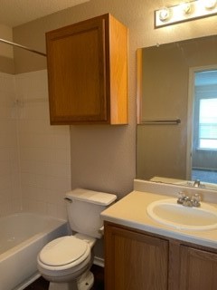 14112 Harris Ridge Boulevard, Unit B Pflugerville, TX 78660 - Photo 7 of 16 a bathroom with a sink a toilet and mirror
