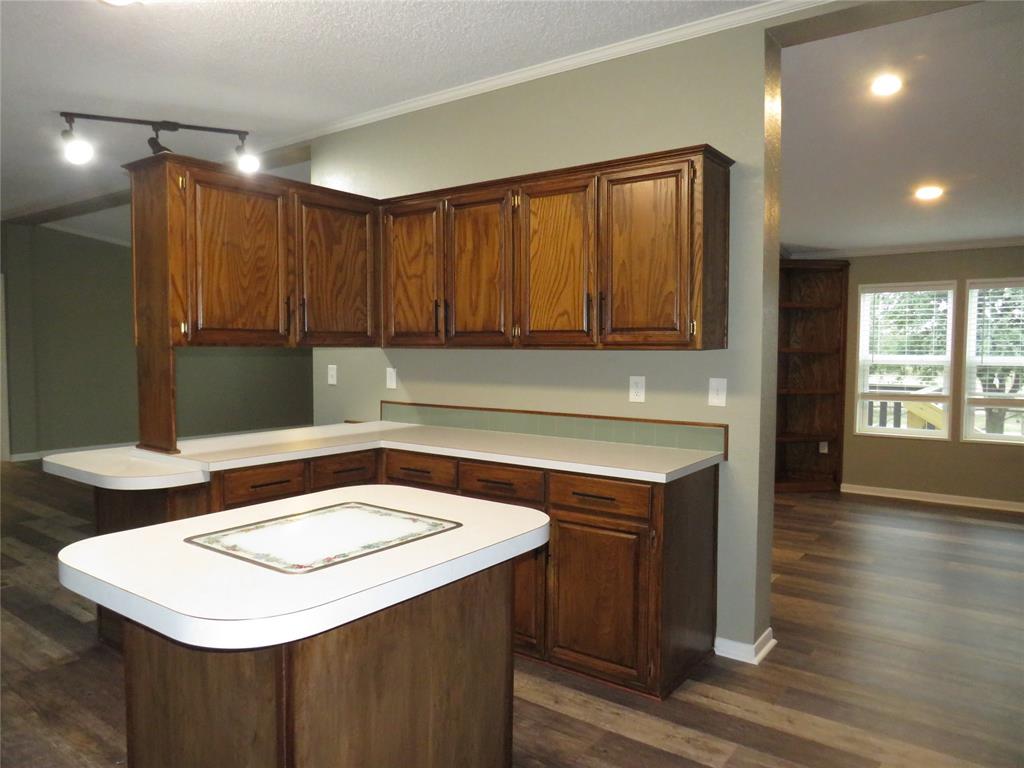 2151 Crockett Road Sanger, TX 76266 - Photo 18 of 30 a kitchen with a sink cabinets and wooden floor