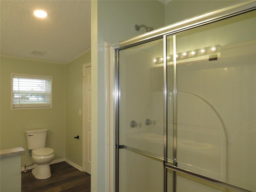 2151 Crockett Road Sanger, TX 76266 - Photo 25 of 30 a bathroom with a shower and a toilet