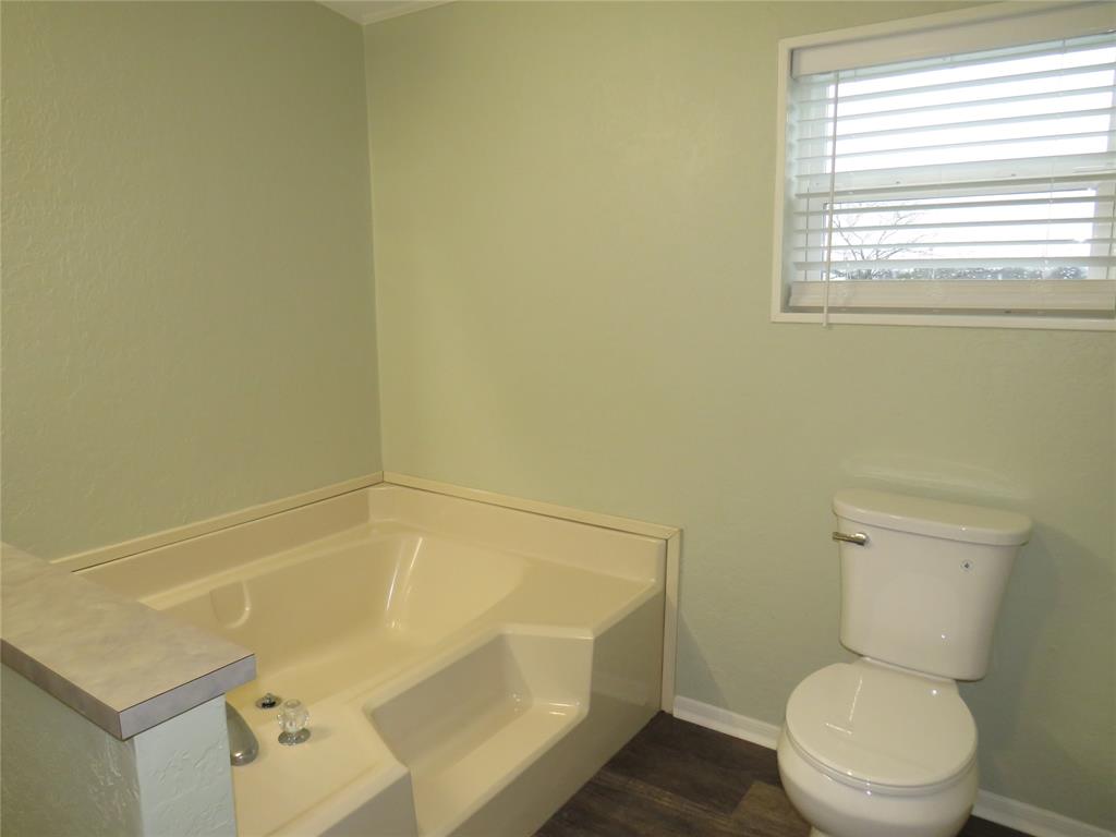 2151 Crockett Road Sanger, TX 76266 - Photo 27 of 30 a bathroom with a toilet and a shower