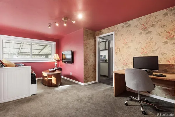 a view of a workspace with furniture and a window