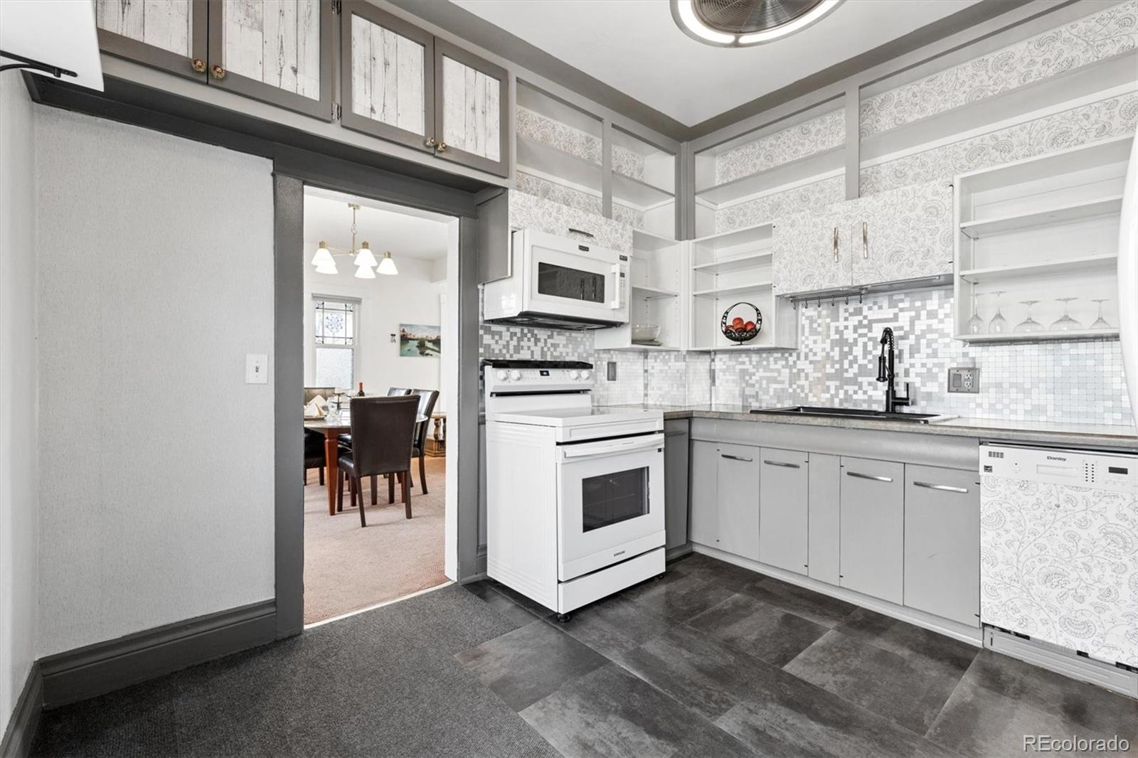1275 Clinton Street Aurora, CO 80010 - Photo 16 of 33 a kitchen with stainless steel appliances granite countertop a stove and a sink